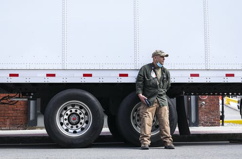 pandemic fatigue man in front of semi truck