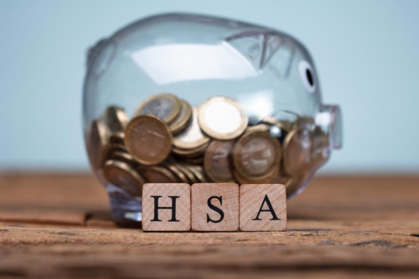 HSA blocks in front of clear piggy bank health savings account